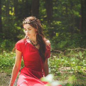 Rabbitwood and Reason website banner:  A Medieval maiden wearing a hand crafted tiara, necklace and earrings rests on the floor of a wooded glade. She is at peace and one with nature.