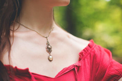 Avalon Pendant Necklace in Cream Pearl and Antiqued Brass by Rabbitwood and Reason. Photo by La Candella Weddings